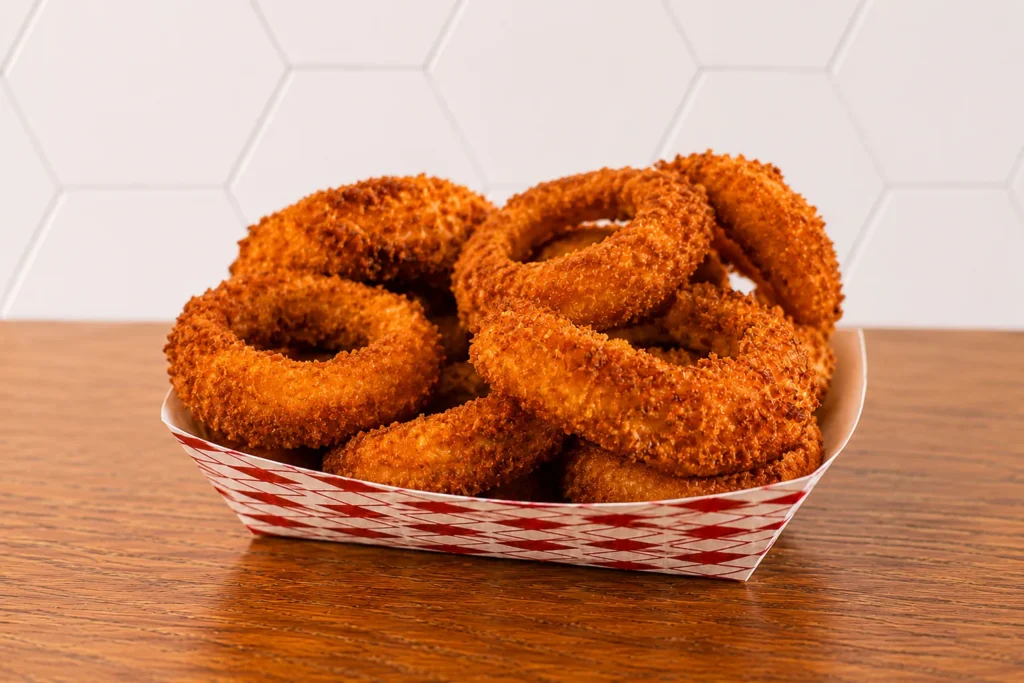 Large Onion Rings: Large serving of crispy golden onion rings with a crunchy seasoned coating.